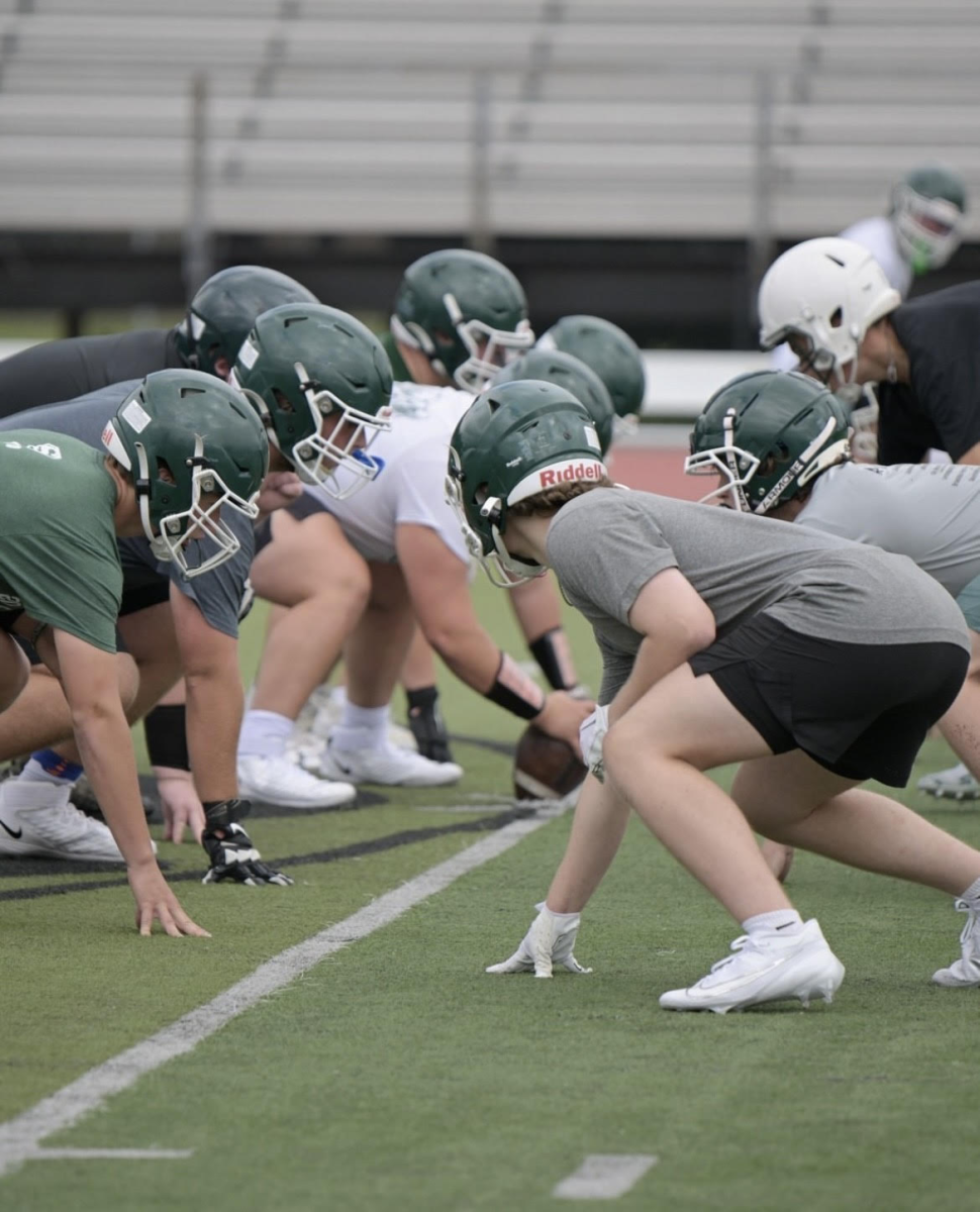 Football athletes practice before the start of their season. 