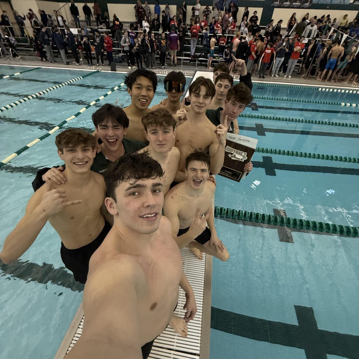 Senior swimmers and divers pose on the bulkhead after learning they had won the Sectional meet. 